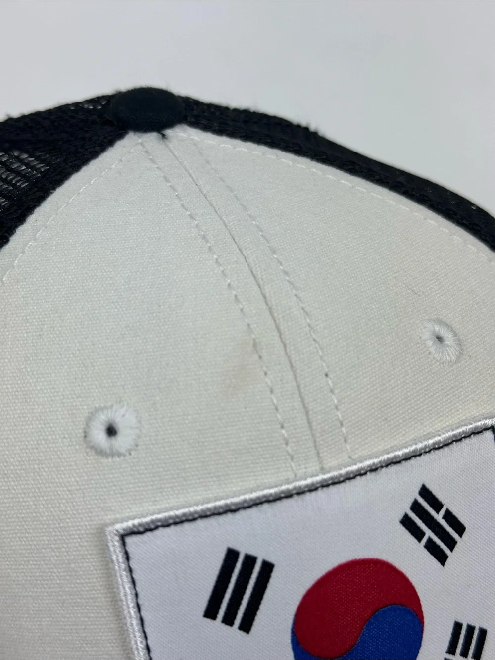 The North Face Black & White Trucker Hat with South Korea Flag Patch
